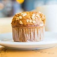 One perfect pumpkin lactation muffin sprinkled with oatmeal.